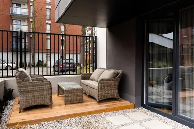 a view of a patio with wicker furniture through a window at Green Boutique Apartment 60m2 & Garage in Kraków