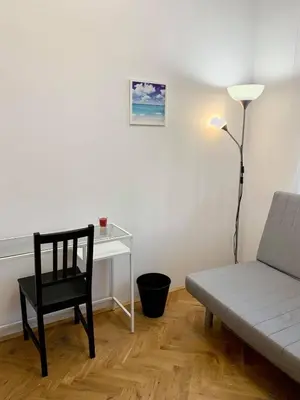 a living room with a desk and a chair and a couch at Enios Rooms ul Jana kochanowskiego 26 in Kraków