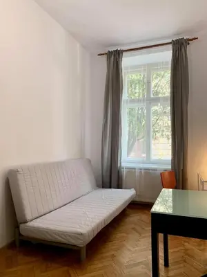 a white bed in a room with a window at Enios Rooms ul Jana kochanowskiego 26 in Kraków