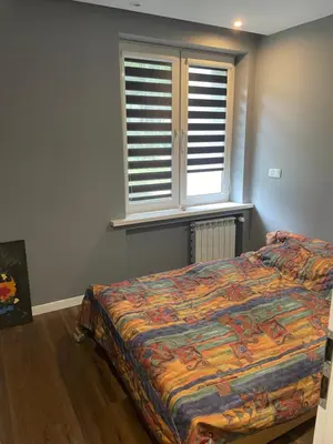 a bedroom with a bed and a window at Monte Cassino Apartament in Oświęcim