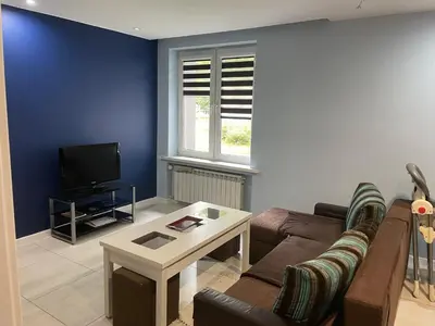 a living room with a couch and a table at Monte Cassino Apartament in Oświęcim