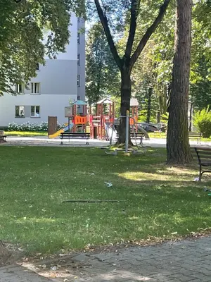 a park with a playground in the grass at Monte Cassino Apartament in Oświęcim