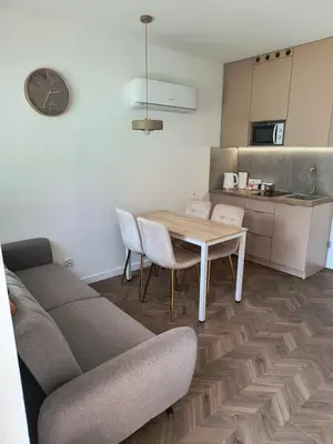 a living room with a couch and a table and chairs at Domki na Górkach in Spytkowice