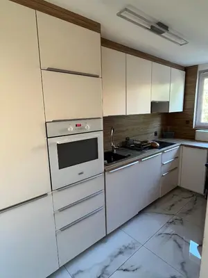 a kitchen with white cabinets and a sink at Pet-friendly 4-person apartment in Oświęcim