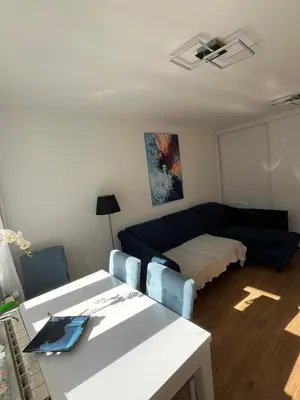 a living room with a couch and a table at Pet-friendly 4-person apartment in Oświęcim