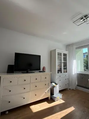 a living room with a television on a dresser at Pet-friendly 4-person apartment in Oświęcim
