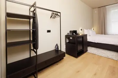a bedroom with a bed and a book shelf at Nomadic Lite in Kraków