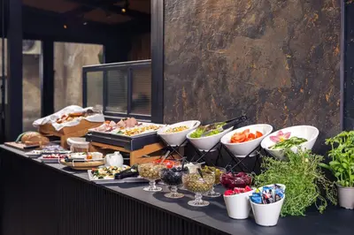 a buffet with appetizers and food on a table at Nomadic Lite in Kraków