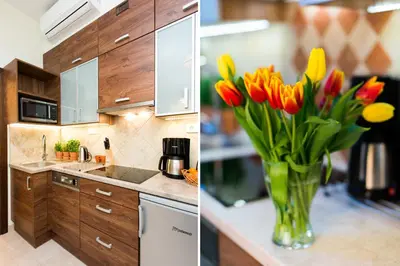 a vase of tulips sitting on a counter in a kitchen at Vanilla 3, 4bdr 2bth apartment 5min to Main Square in Kraków