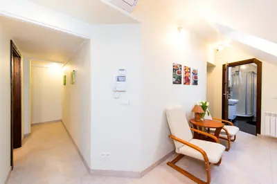 a living room with a table and chairs at Vanilla 3, 4bdr 2bth apartment 5min to Main Square in Kraków