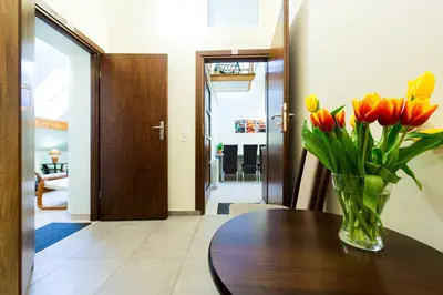 a vase of orange tulips sitting on a table at Vanilla 3, 4bdr 2bth apartment 5min to Main Square in Kraków