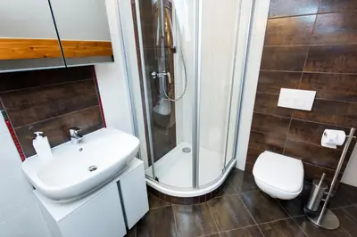 a bathroom with a shower and a sink and a toilet at Vanilla 3, 4bdr 2bth apartment 5min to Main Square in Kraków