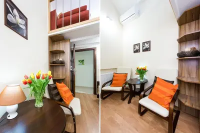 a living room with orange pillows and a table and chairs at Vanilla 3, 4bdr 2bth apartment 5min to Main Square in Kraków