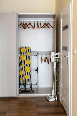 a room with a door with a rack of utensils at Apartament Orawska U Pana Cogito in Kraków