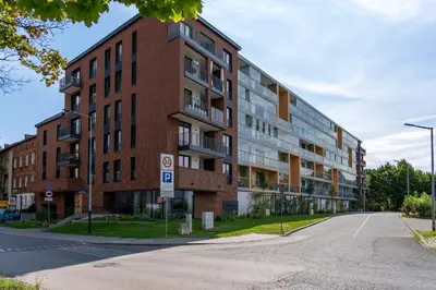 an empty street in front of a brick building at Apartament Orawska U Pana Cogito in Kraków