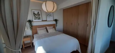 a bedroom with a white bed and a wooden door at MAnGo68 in Zator