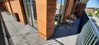 a balcony with a wooden column on a building at MAnGo68 in Zator