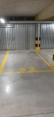 an empty parking garage with a parking sign on the floor at MAnGo68 in Zator