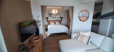 a living room with a couch and a tv and a bed at MAnGo68 in Zator