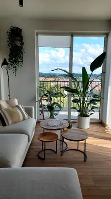 a living room with a couch and two tables at MAnGo68 in Zator