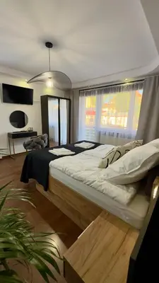 a bedroom with a large bed in a room at Apartamenty Oracka Przystań Solna 2 in Bochnia