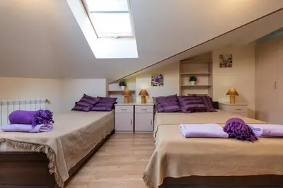 two beds in a room with purple pillows at Vanilla 4, 3bdr 1,5bth apartment in city centre in Kraków
