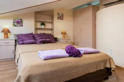 two beds in a room with purple pillows at Vanilla 4, 3bdr 1,5bth apartment in city centre in Kraków