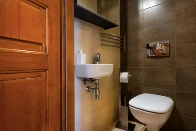 a bathroom with a white toilet and a sink at Vanilla 4, 3bdr 1,5bth apartment in city centre in Kraków