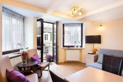 a living room with a couch and a table at Vanilla 4, 3bdr 1,5bth apartment in city centre in Kraków