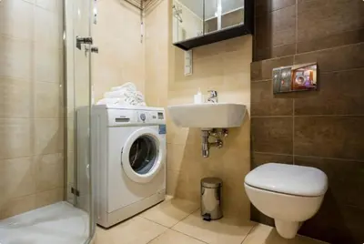 a bathroom with a washing machine and a sink at Vanilla 4, 3bdr 1,5bth apartment in city centre in Kraków