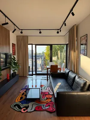 a living room with a leather couch and a table at Novum Escape in Kraków