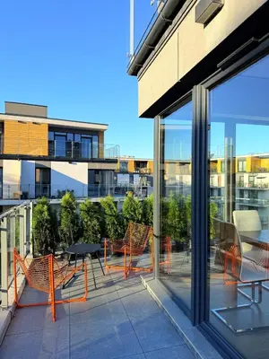 a patio with tables and chairs on a building at Novum Escape in Kraków