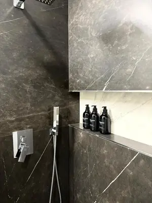 a group of bottles sitting on a shelf in a bathroom at Novum Escape in Kraków