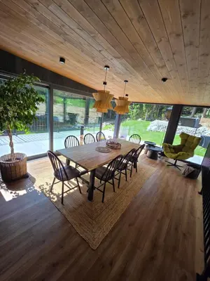 a dining room with a wooden table and chairs at Chillout Kocoń nowoczesny dom w górach in Kocoń