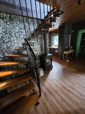 a room with a staircase and a wall with a fireplace at Chillout Kocoń nowoczesny dom w górach in Kocoń