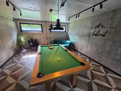 a pool table in the middle of a room at Chillout Kocoń nowoczesny dom w górach in Kocoń