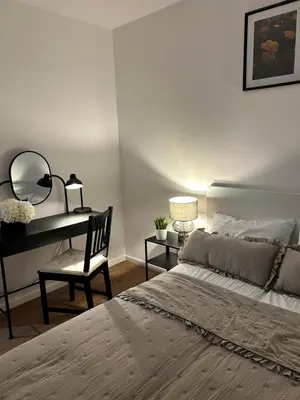 a bedroom with a bed and a desk with a mirror at Vetaluniego Apartment High quality in Kraków