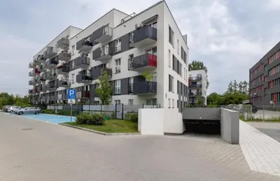 a white apartment building on a city street at Vetaluniego Apartment High quality in Kraków