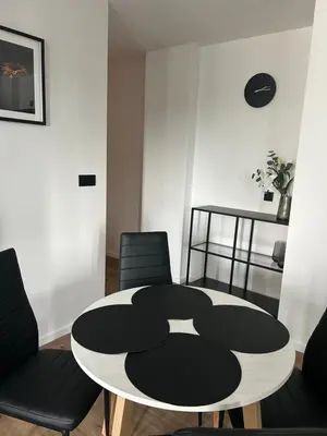 a dining room with a table and two chairs at Vetaluniego Apartment High quality in Kraków