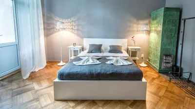 a bedroom with a bed with two towels on it at Sereno Apartments in Kraków