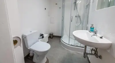 a bathroom with a toilet and a sink and a shower at Sereno Apartments in Kraków