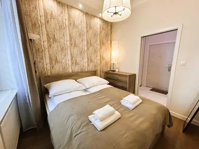 a bedroom with a large bed with two towels on it at Old Town Apt - Traugutta Street flat 5 in Kraków