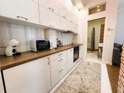 a kitchen with white cabinets and a microwave at Old Town Apt - Traugutta Street flat 5 in Kraków