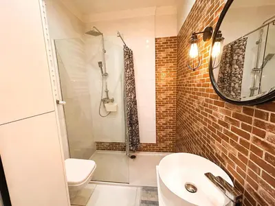 a bathroom with a sink and a toilet and a mirror at Old Town Apt - Traugutta Street flat 5 in Kraków