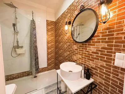 a bathroom with a white sink and a mirror at Old Town Apt - Traugutta Street flat 5 in Kraków