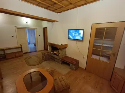 a living room with a fireplace and a tv on the wall at Apartament Żmiąca in Jaworzna