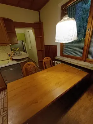 a kitchen with a wooden table in a room at Apartament Żmiąca in Jaworzna