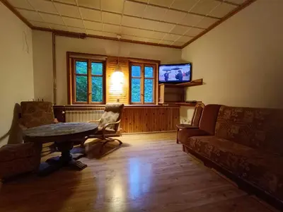 a living room with a table and a couch and a tv at Apartament Żmiąca in Jaworzna