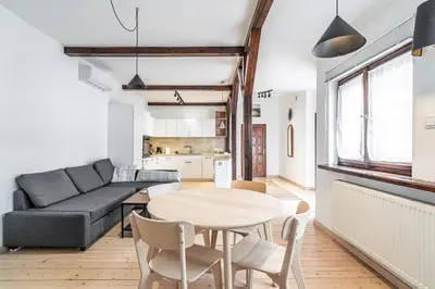 a living room with a table and a couch at RentPlanet - Apartament przy Plantach in Kraków