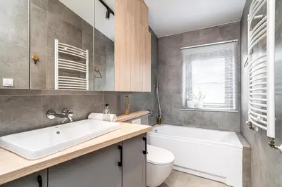 a bathroom with a sink and a tub and a toilet at RentPlanet - Apartament przy Plantach in Kraków